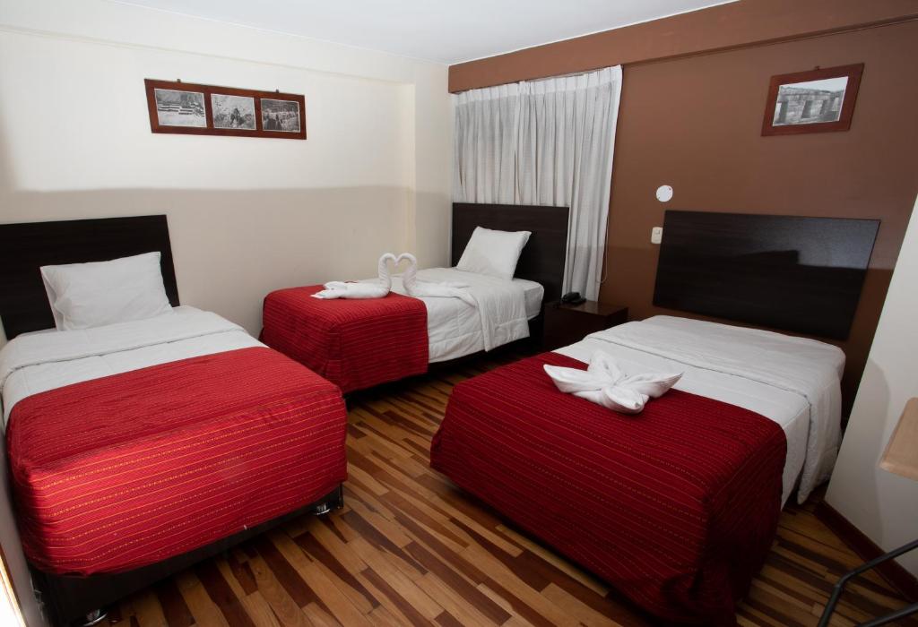 Postel nebo postele na pokoji v ubytování Kapac Inn Hotel