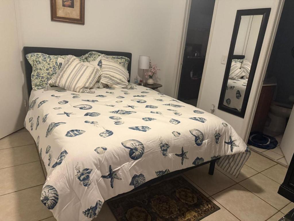 a bed with a comforter and pillows in a bedroom at Private Studio in Kissimmee