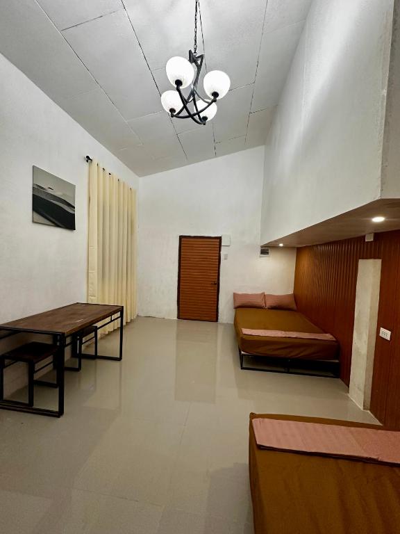 a living room with a couch and a table at Bgs Place Moalboal in Moalboal