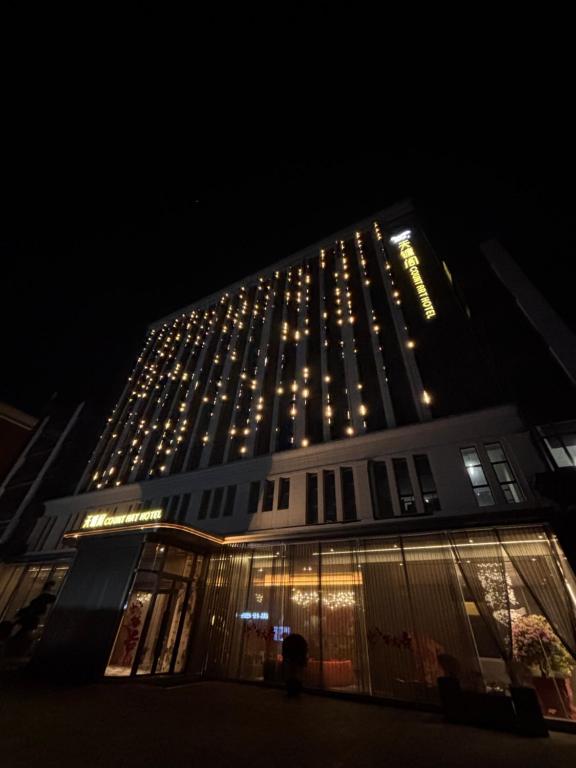 a large building with lights on it at night at Tianyongge Art Hotel Shanghai Disney Store in Shanghai