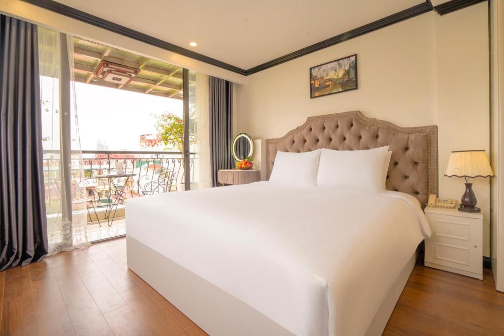 Postel nebo postele na pokoji v ubytování Hotel Du Palace
