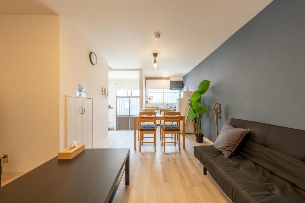 a living room with a couch and a table at BPhouse森ノ宮第二 in Osaka