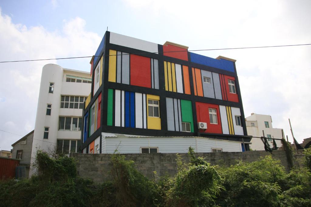 a building with many colors on the side of it at The Beauty of Basalt B&amp;B in Magong