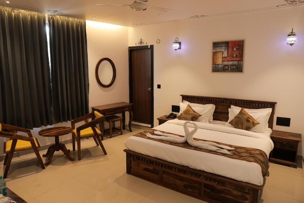 a bedroom with a bed with a bird on it at Hotel Paras Chittorgarh in Chittaurgarh