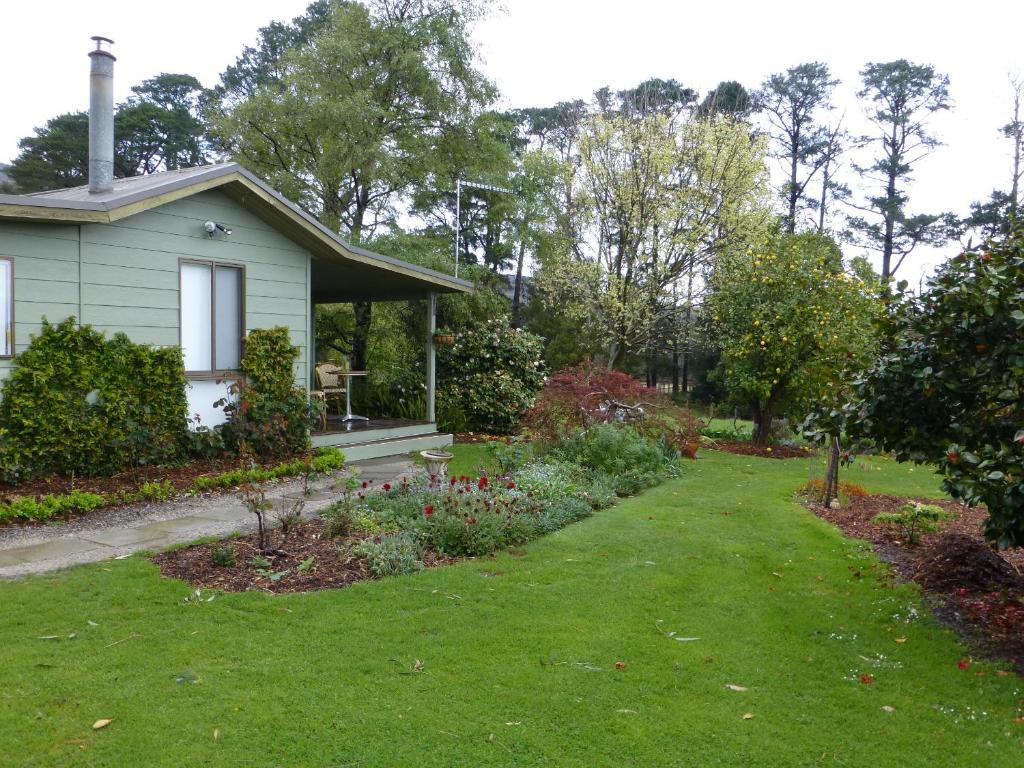 a house with a garden in front of it at The Little House on The Hill in Badger Creek