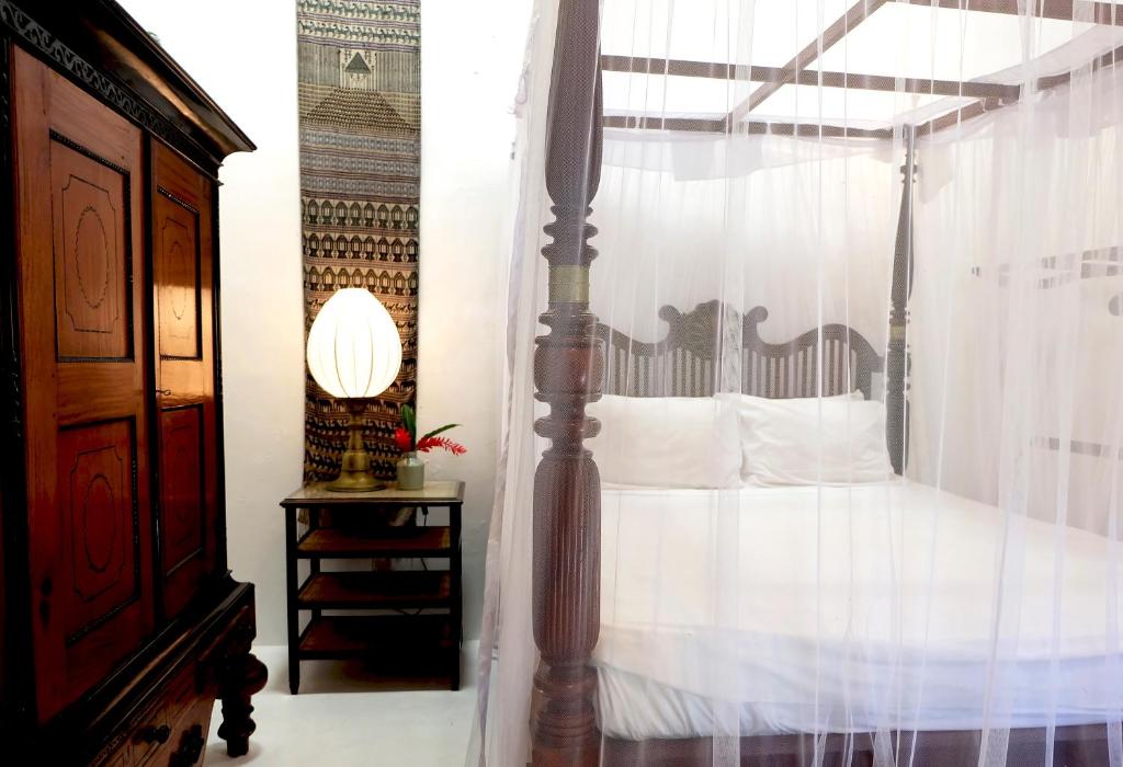 Postel nebo postele na pokoji v ubytování Orchard House Galle