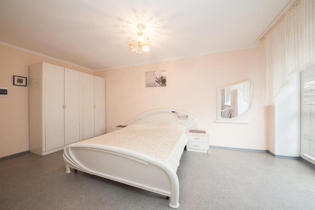 a hospital room with a bed and a chandelier at Kvartirov Apartments City in Krasnoyarsk