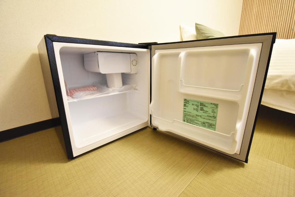 Postel nebo postele na pokoji v ubytování 民泊富士なんば MinpakuFujiNamba