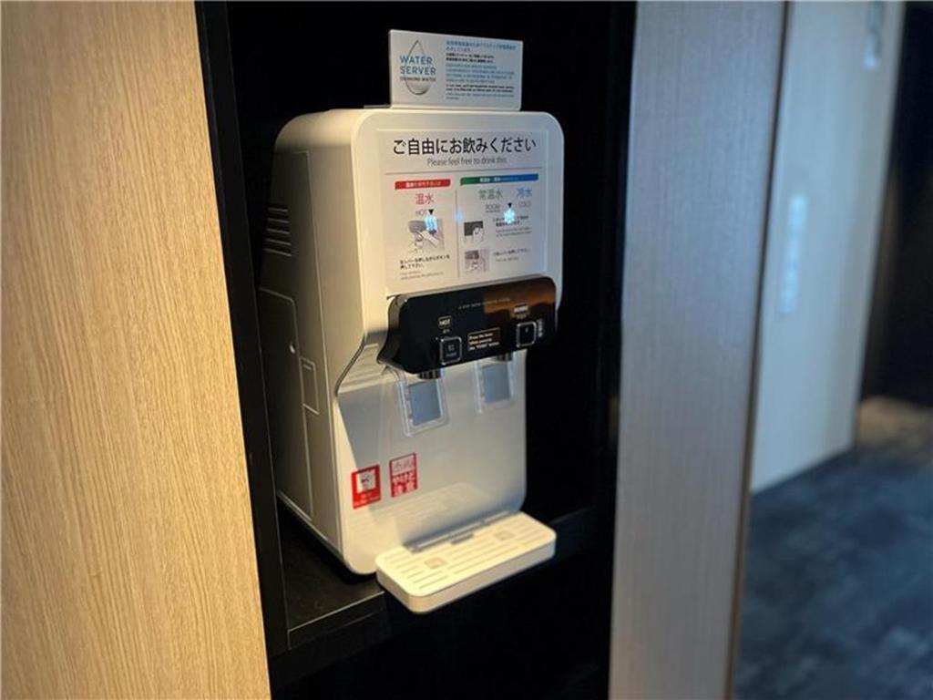 a machine in a wall in a room at JR Kyushu Hotel Blossom Shinjuku in Tokyo