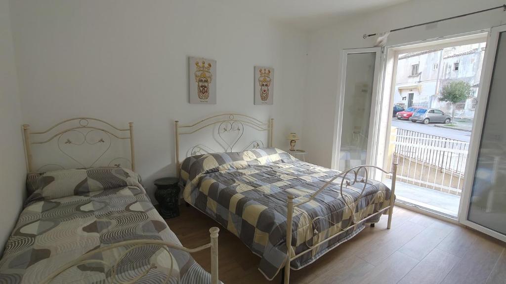 En eller flere senge i et værelse på La casetta Bianca