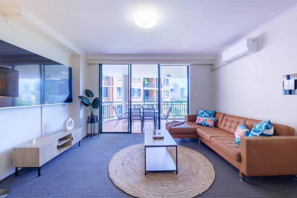 a living room with a couch and a table at 5mins Walk to Central 2 Bedroom Parking Pool in Sydney