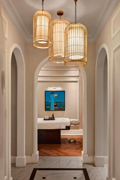 A grand, arched dressing passage leads toward a treatment or vanity area.