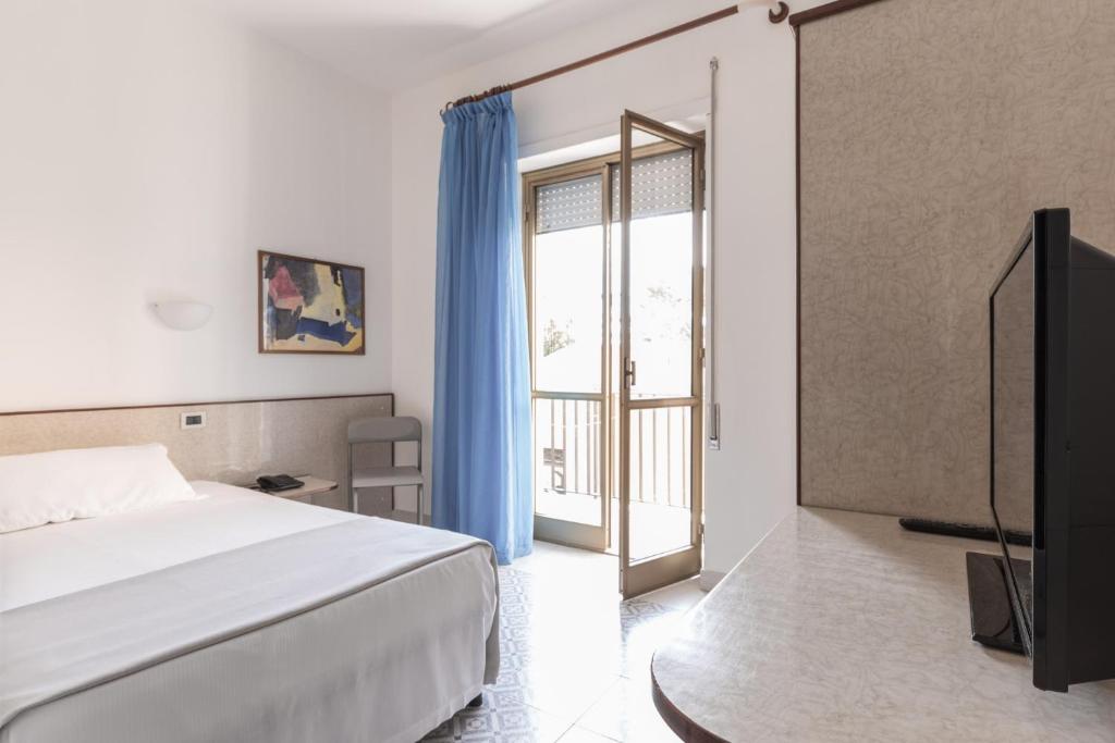 Postel nebo postele na pokoji v ubytování Hotel Serapo