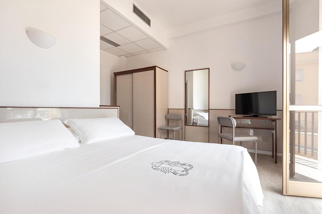 Postel nebo postele na pokoji v ubytování Hotel Serapo