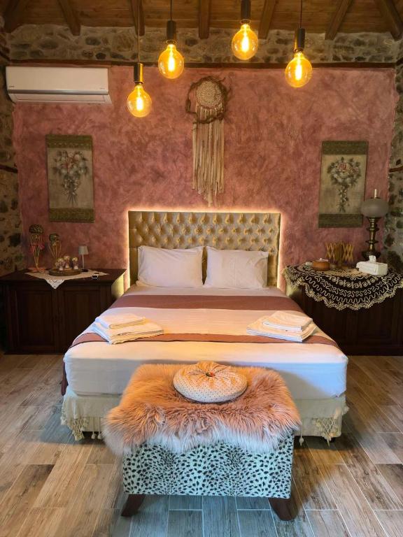 a bedroom with a large bed with a rug on it at Luxury Suites in Villa Anasia, Amaryllis in Skotina