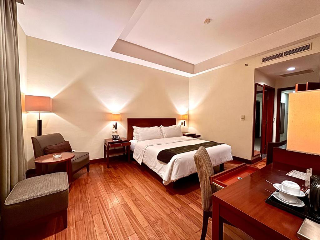 Postel nebo postele na pokoji v ubytování Manado Quality Hotel