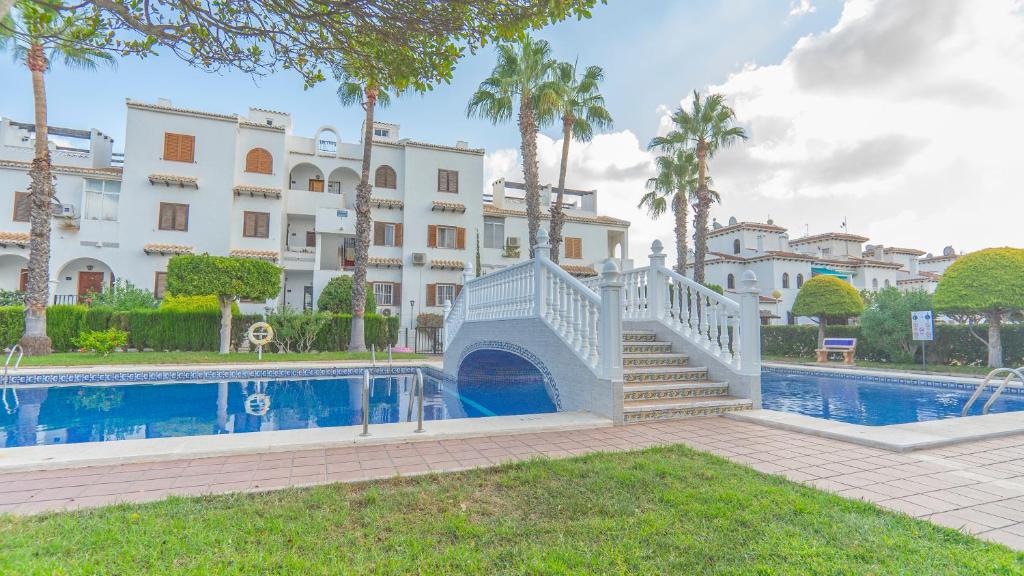 a swimming pool with a staircase next to a building at Bravo Hills - Casa Jean in Ciudad Quesada