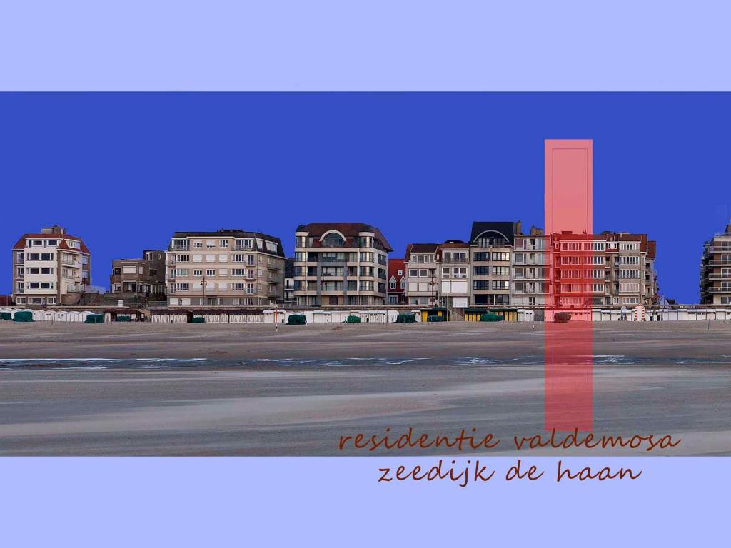 a red cross in front of a city with buildings at Apartment Valdemosa in De Haan