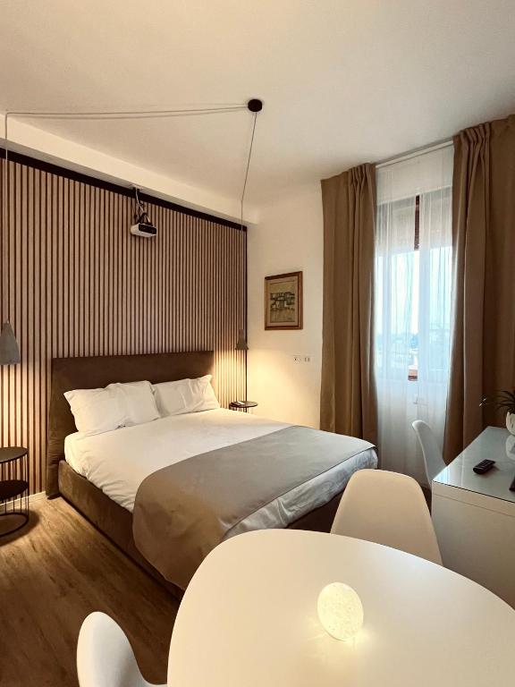 a bedroom with a bed and a table and chairs at Oriani39 B&B in Bologna