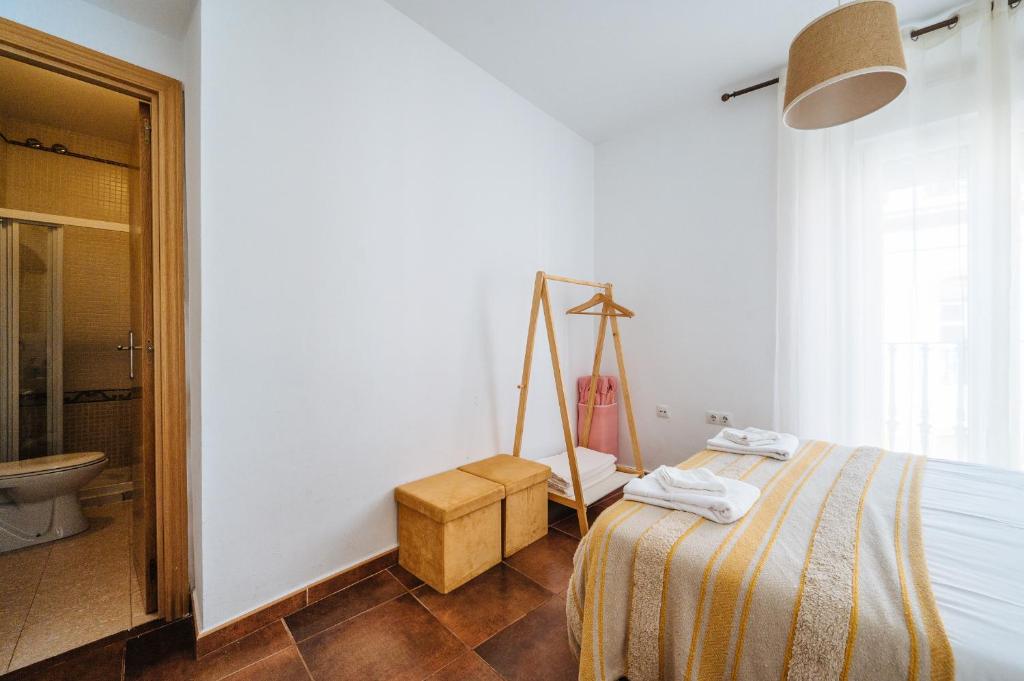 A bed or beds in a room at HomeySeville-Lovely Duplex at Santa Cruz 10 pax, Parking Optional