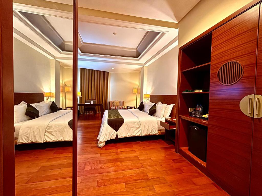 Postel nebo postele na pokoji v ubytování Manado Quality Hotel