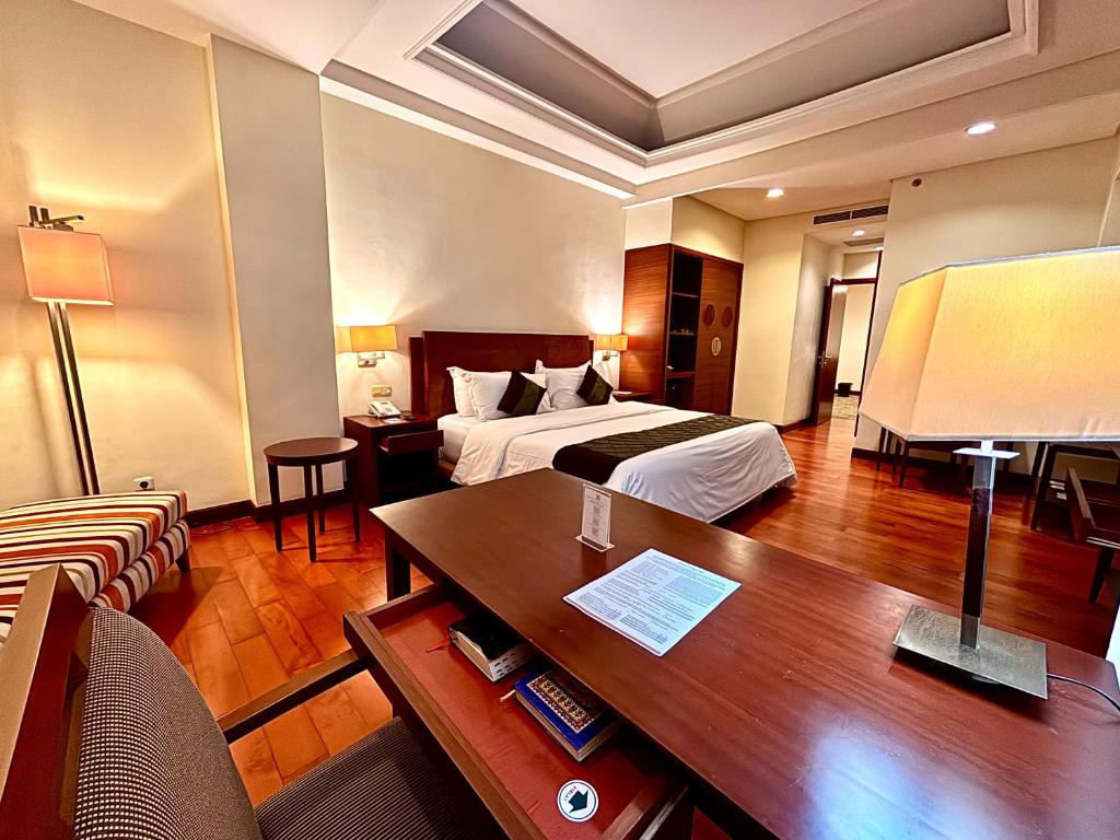 Postel nebo postele na pokoji v ubytování Manado Quality Hotel
