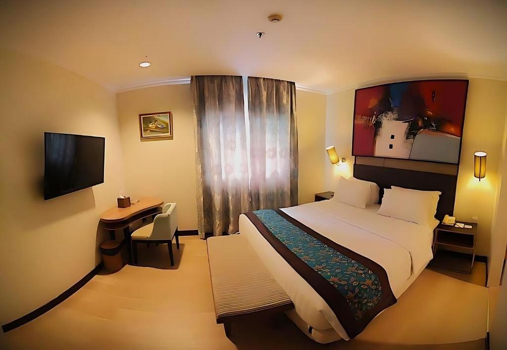 Postel nebo postele na pokoji v ubytování BRITS HOTEL PANGKALAN BUN