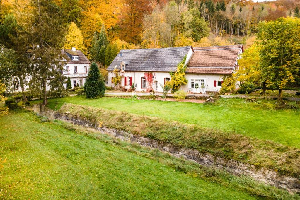 a house on a hill with a green yard at Gut Neuwerk in Kall