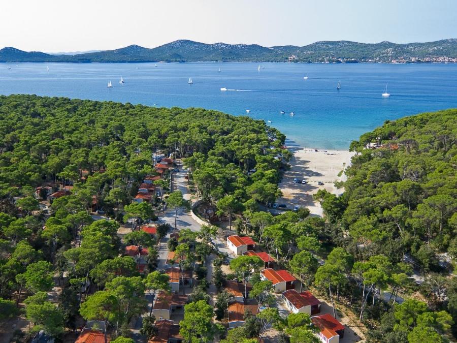 an aerial view of a beach with houses and trees at Camping Park Soline Pitches in Biograd na Moru