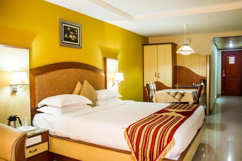 Postel nebo postele na pokoji v ubytování PonmariResidency