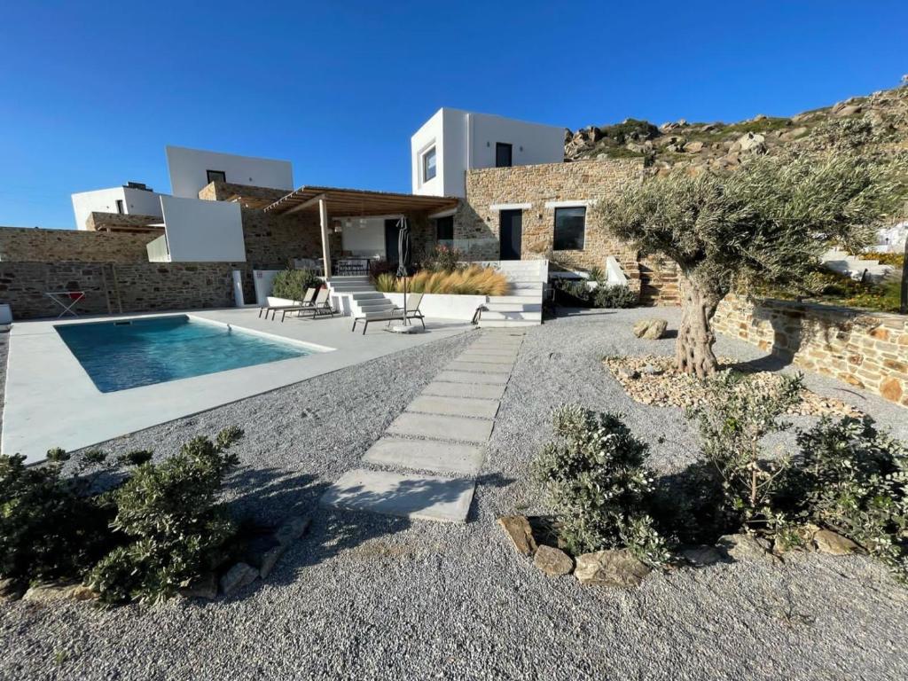 a villa with a swimming pool and a house at Villa Andalusia in Naxos Chora