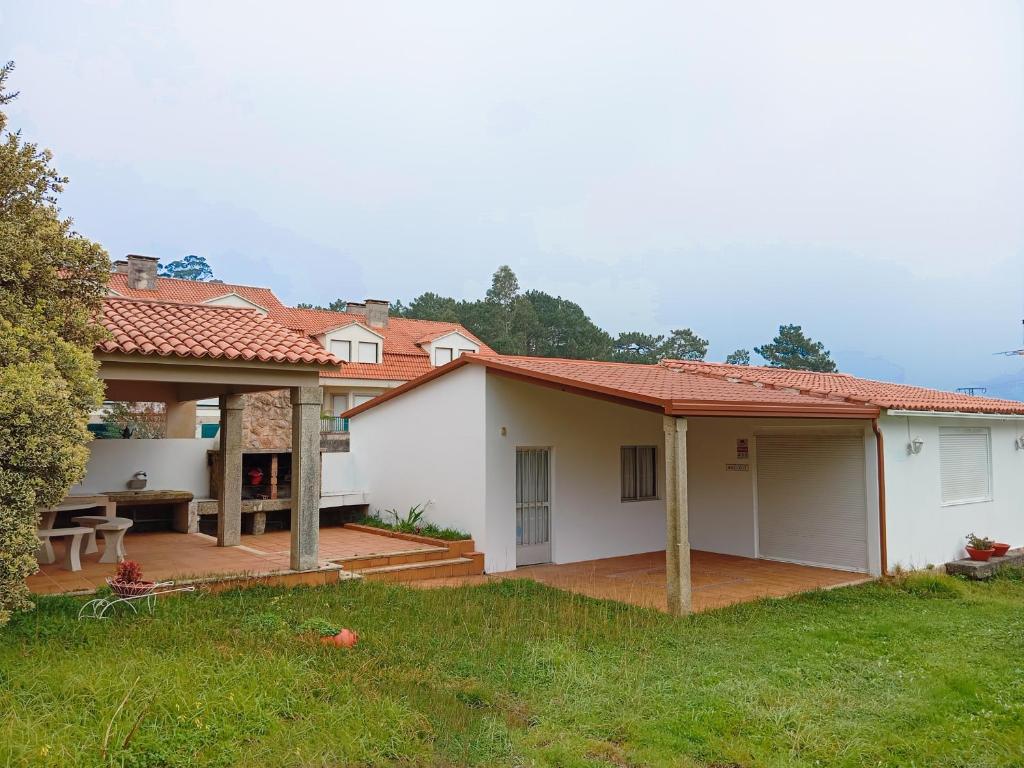 a house with a porch and a patio at Casa San Vicente Do Mar 3000 in O Grove
