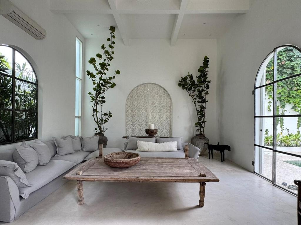 a living room with a couch and a coffee table at Poem House Bali in Munggu