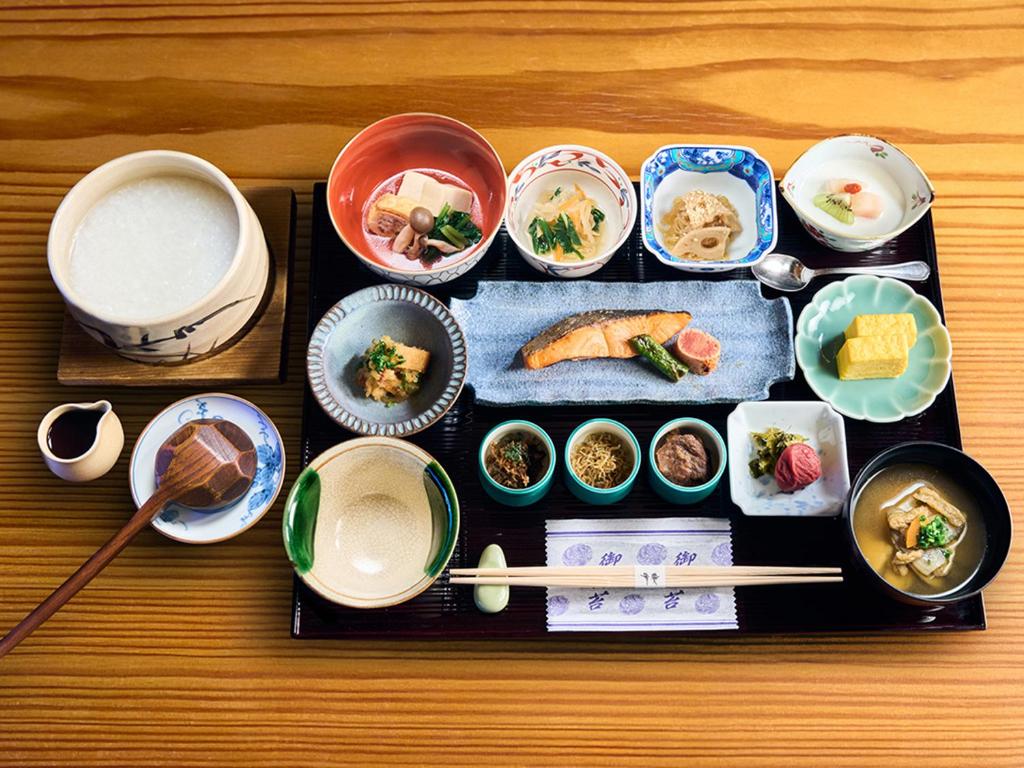 a table topped with bowls and plates of food at Hotel Nikko Kumamoto in Kumamoto