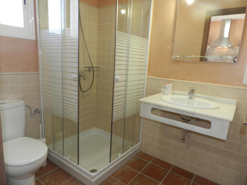 a bathroom with a shower and a toilet and a sink at DADA CAÑOS in Los Caños de Meca