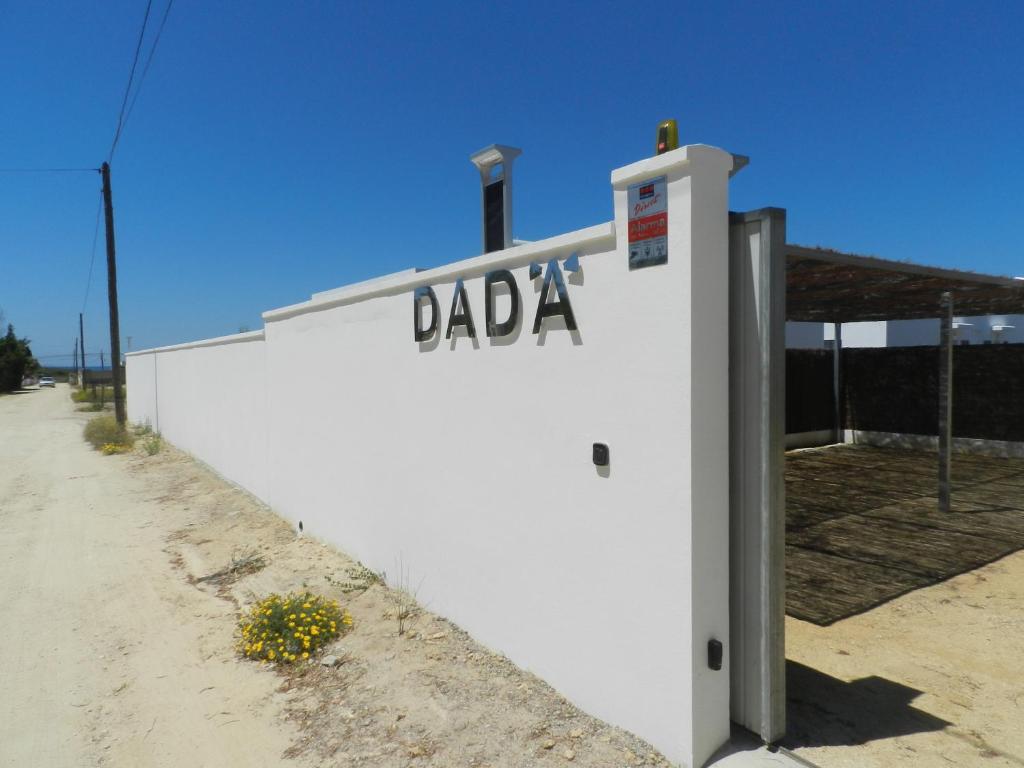 a white building with a sign on the side of it at DADA CAÑOS in Los Caños de Meca