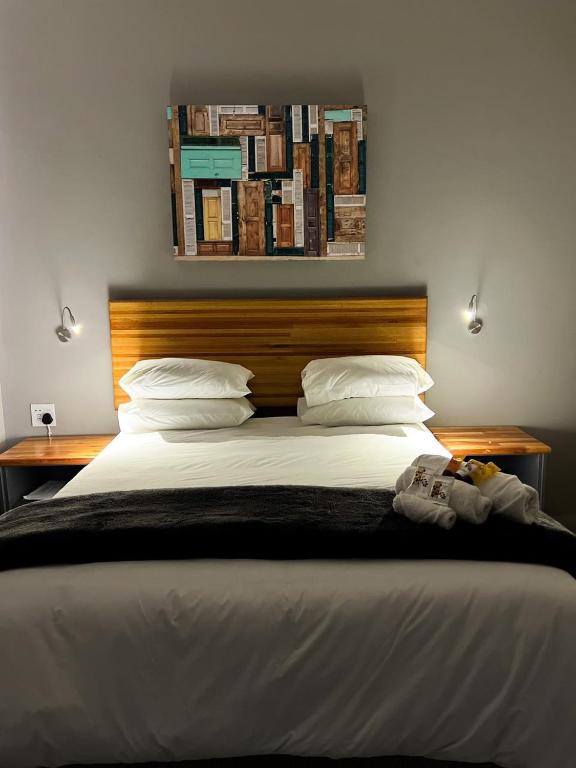 a bedroom with a large bed with white sheets and pillows at Riecor Guest Farm in Thabazimbi