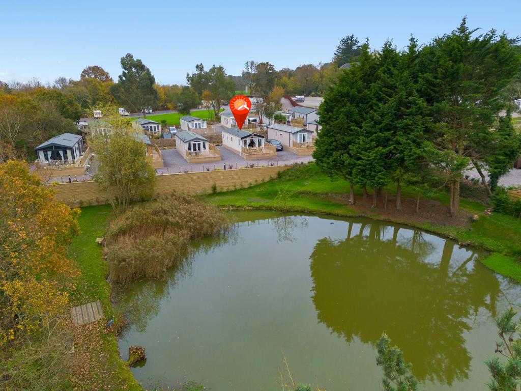 an aerial view of a pond with a kite in the sky at Lake View Holiday Home - Fishing Lakes, Heated Outdoor Swimming Pool 500yrds on Sister Park, Pool Shut for the winter open April 2026 in Exeter