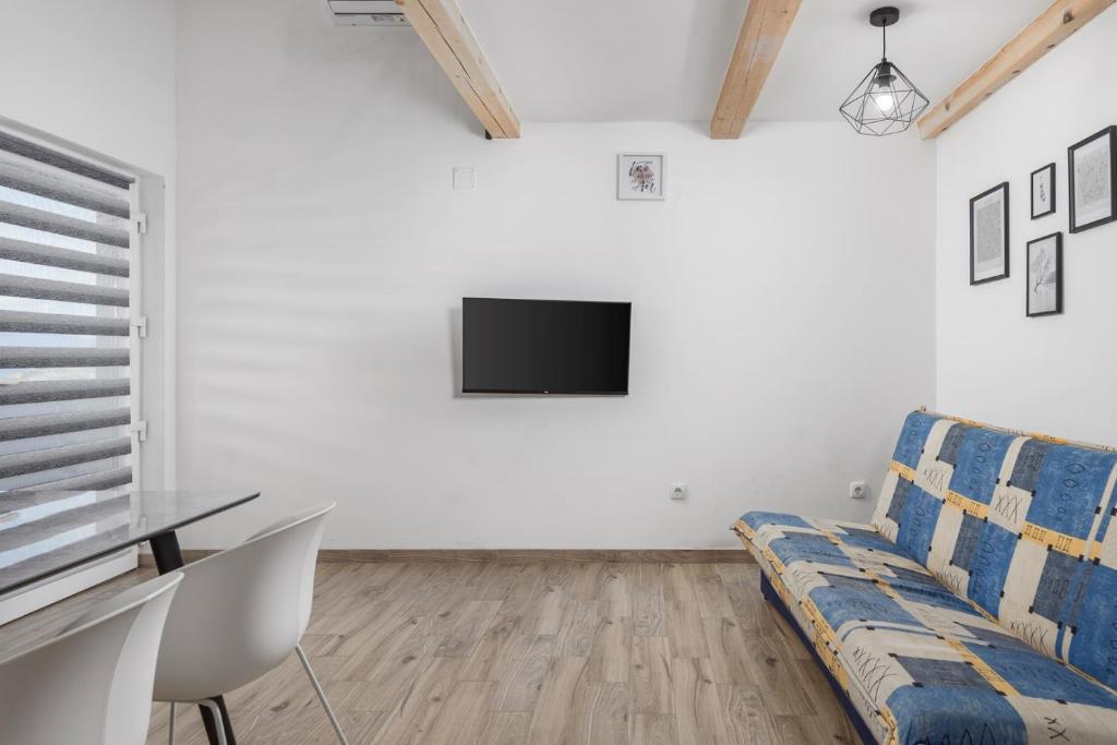 Televízia a/alebo spoločenská miestnosť v ubytovaní Villa Vuka