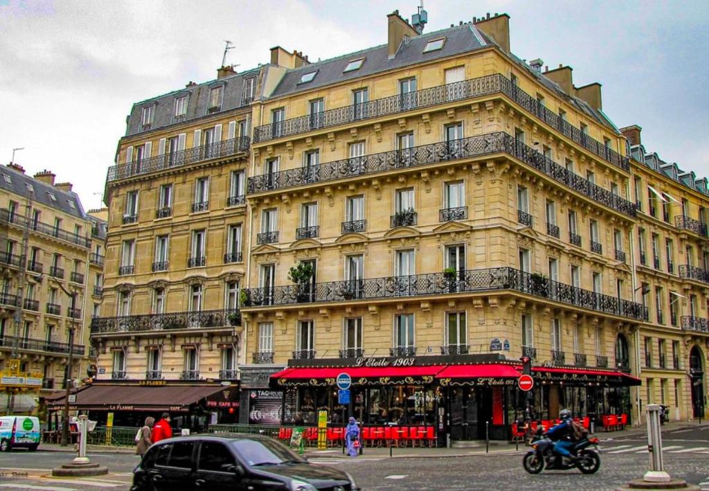 a large yellow building with balconies on a street at Chic Apartment Arc de Triomphe-Champs Élysées in Paris