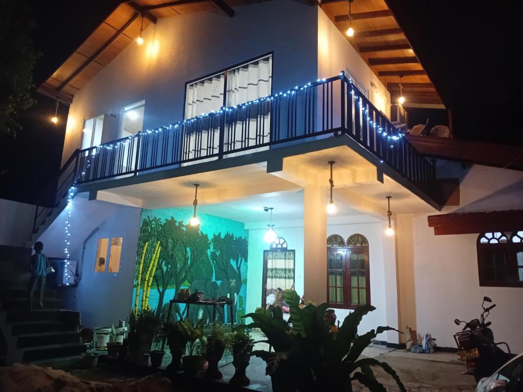 a house with a staircase on the side of it at Cinnamon garden villa in Weligama