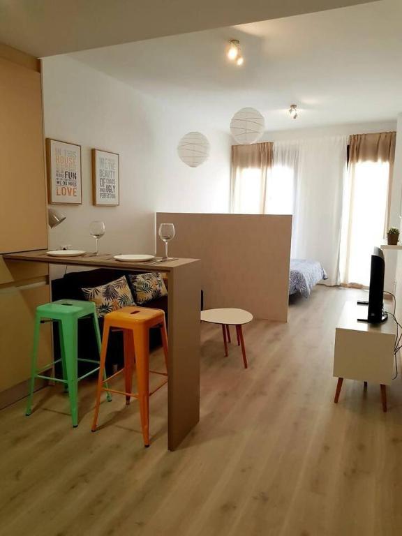 a living room with a table and some chairs at LovelyLoft Pablo Old Town in Alicante