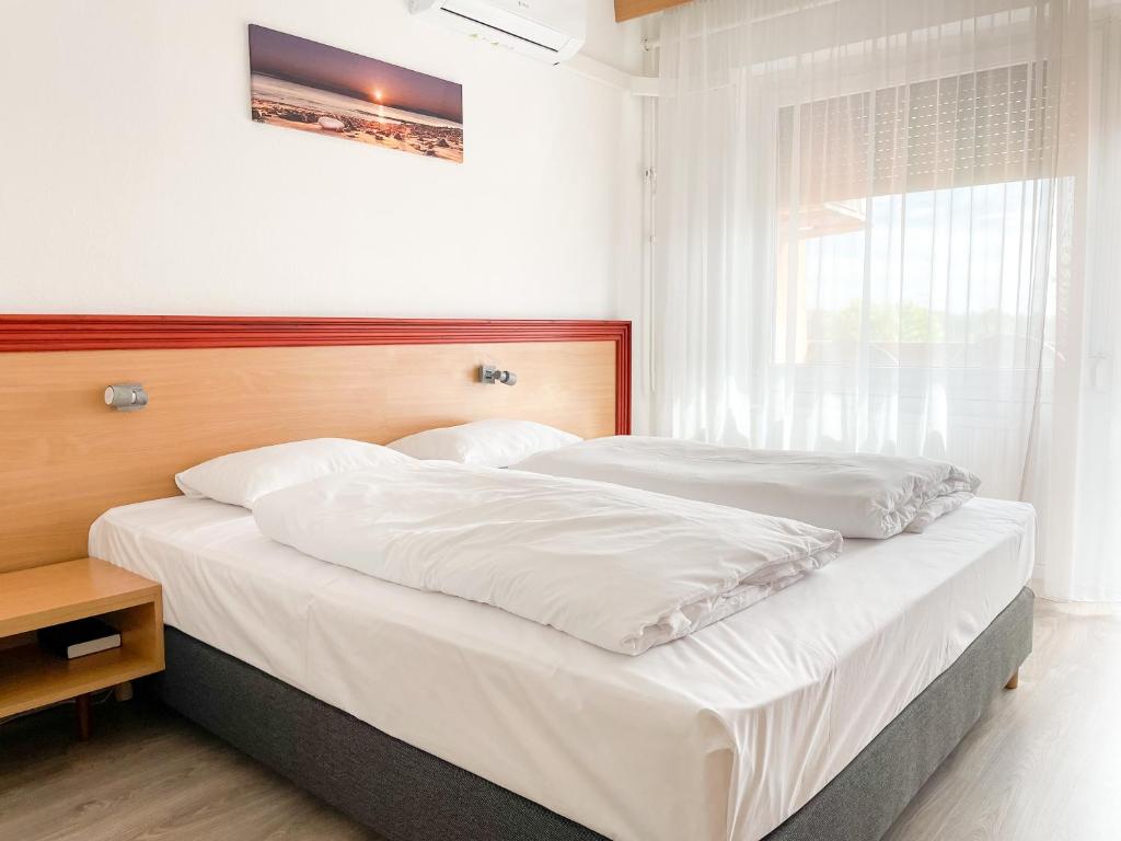 Postel nebo postele na pokoji v ubytování Tisza Sport Hotel