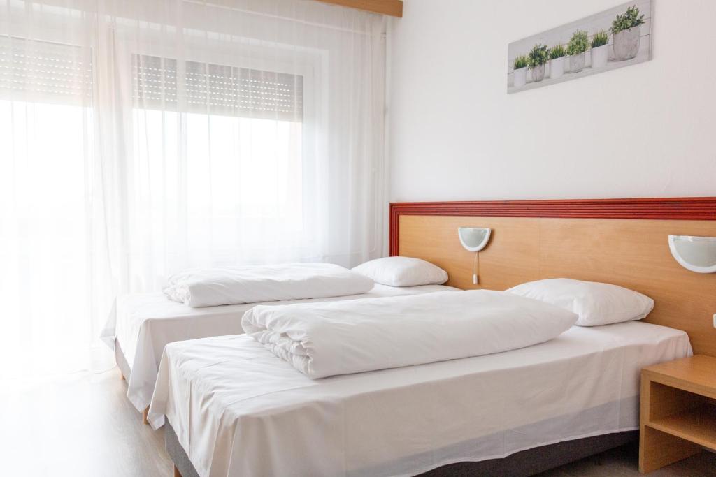 Postel nebo postele na pokoji v ubytování Tisza Sport Hotel