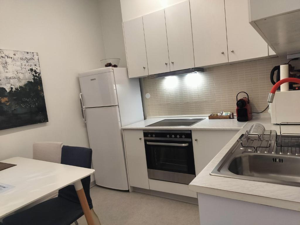 A kitchen or kitchenette at Apollonas Downtown - 1BR Lux Apartment - Tsimiski Ladadika - Explore Center by foot - Close to Aristotelous square