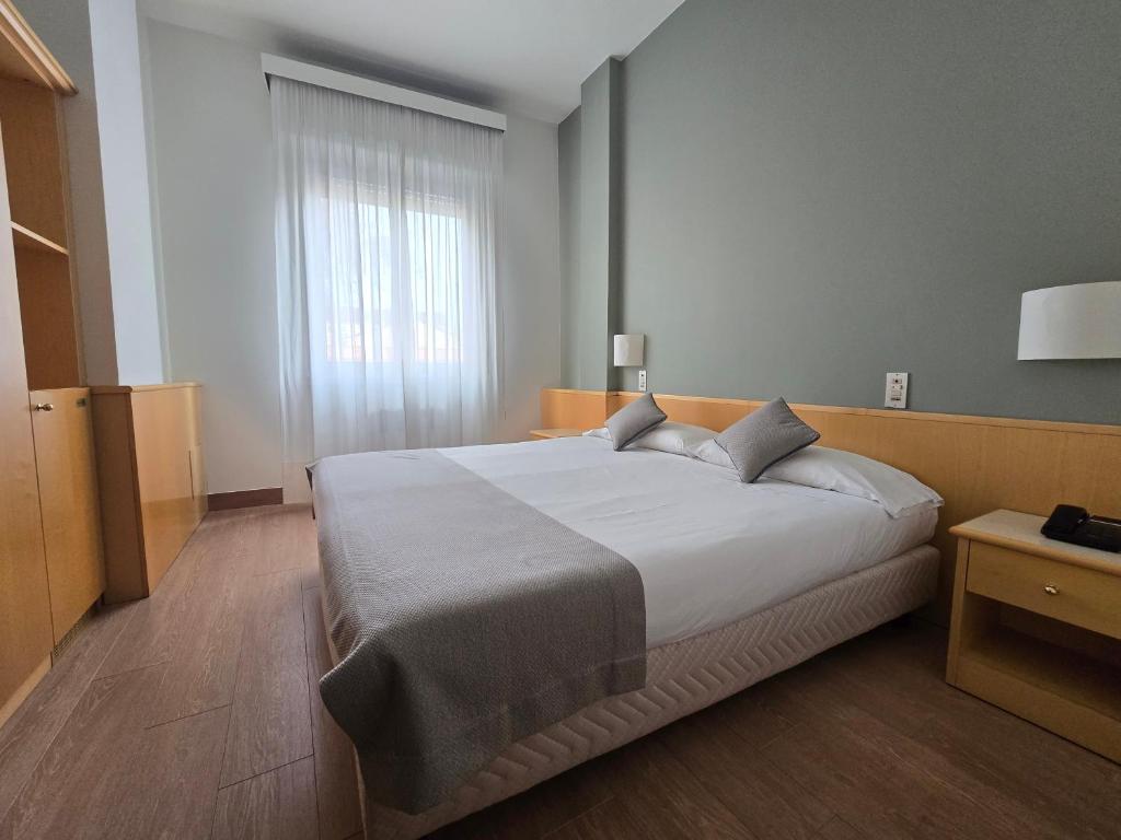 Posteľ alebo postele v izbe v ubytovaní Mokinba Hotels Sant'Ambroeus