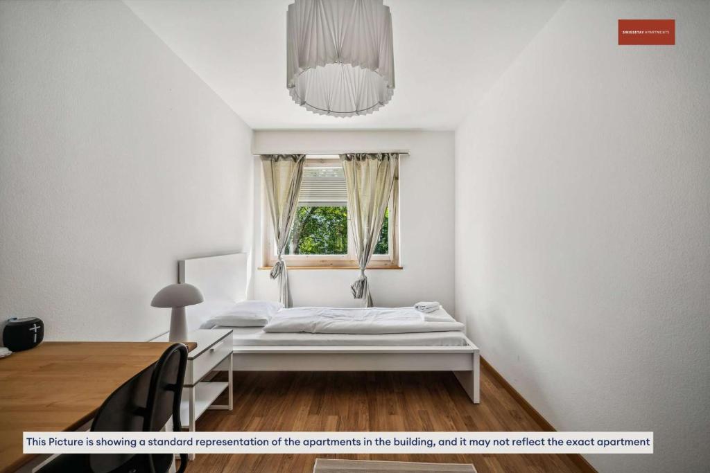Postel nebo postele na pokoji v ubytování Simple and Cozy Flat in Zurich