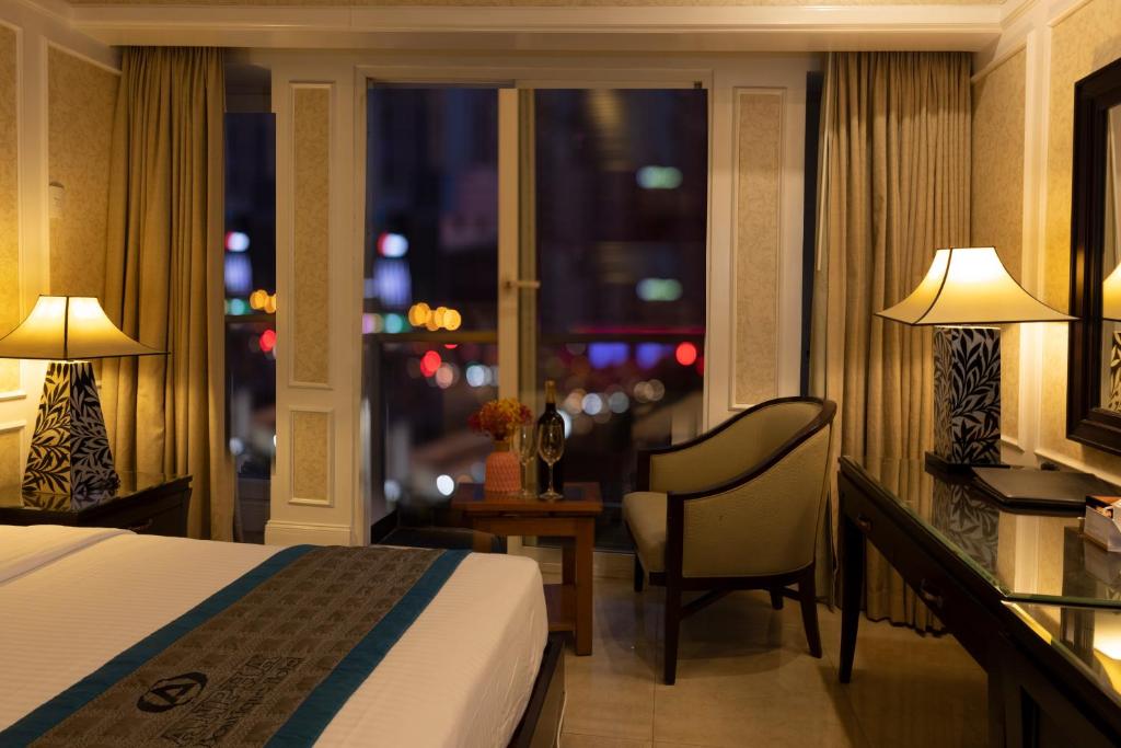 a hotel room with a bed and a window at Anpha Boutique Hotel in Ho Chi Minh City