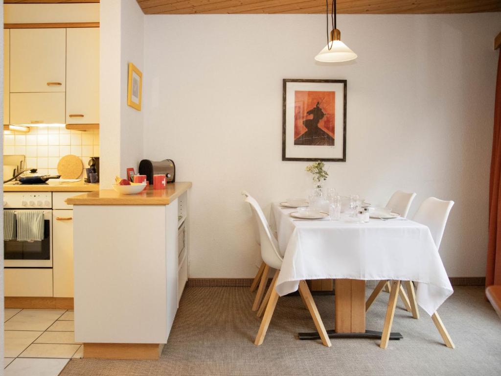 a kitchen and dining room with a table and chairs at Apartment Chalet Abendrot apARTments-20 by Interhome in Grindelwald