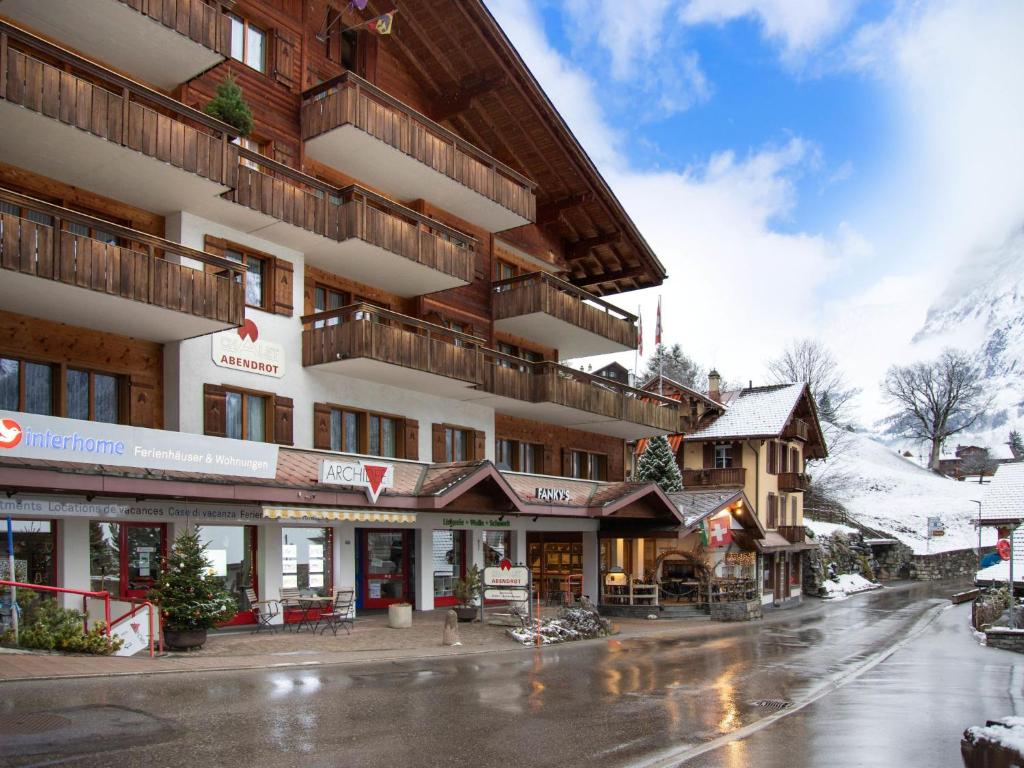 a building on a street in the snow at Apartment Chalet Abendrot apARTments-4 by Interhome in Grindelwald